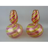 Pair of cranberry and vaseline swirl glass vases