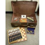 Vintage suitcase and contents including a modern chess set, set of balance scales etc