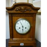 Oak encased circular dial mantel clock with eight day German striking movement