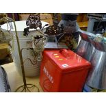 Metal bin containing metal jugs, red metal bread bin and an ornate tea light stand