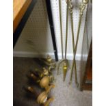 Three brass fire irons and two pairs of fire dogs