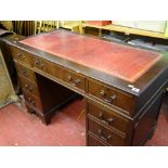 Reproduction mahogany twin pedestal desk with gilt tooled red leather top