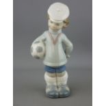 Lladro porcelain figurines of a young boy with football