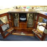 An inlaid two-door glazed smoker's cabinet