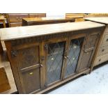 A good carved & glazed bookcase / bookcase cupboard, 134cms wide Condition reports are provided on