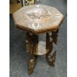 An Indian carved octagonal two-tier coffee table Condition reports are provided on request by