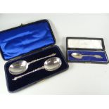 A cased christening spoon with Humpty Dumpty character finial together with a cased pair of