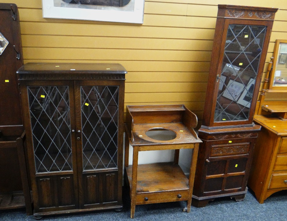 A carved & glazed corner cupboard, an antique wash basin stand & a glazed and linenfold bookcase