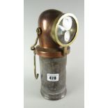 An unusual antique copper capped & brass miner's lamp with suspension, 23cms high Condition