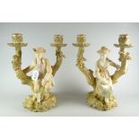 A pair of Royal Worcester figural twin candle holders in the form of lady and gentleman seated on