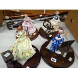 A set of four Royal Doulton figures from 'The Gentle Arts' series, each with certificate & on wooden