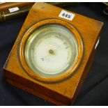 A late nineteenth century brass encased circular dial barometer by C W DIXEY in a glazed oak case