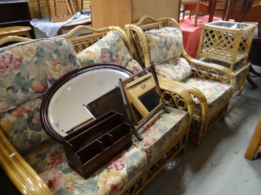 A modern bamboo effect conservatory suite with floral cushions & including two glass top tables