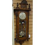 An antique walnut veneer Vienna-type wall clock of architectural form with Roman numeral dial,