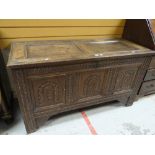 An early nineteenth century carved oak blanket chest, two of the three front panels converted to