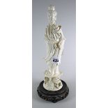 A blanc de chine figurine of Guanyin on a hardwood stand Condition reports are provided on request