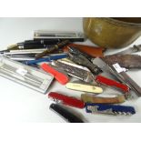 A brass pan containing pens, pen knives ETC Condition reports are provided on request by email