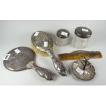 A part-silver dressing table set including ring tree, each with cherubic relief decoration Condition