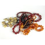Three vintage bead necklaces including amber type together with a collection of brass regimental