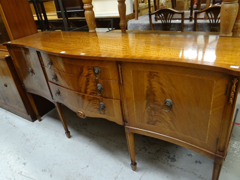 A reproduction mahogany serpentine sideboard together with two similar style lounge units