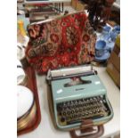 A vintage carpet bag & a cased typewriter Condition reports are provided on request by email only