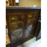 A good vintage linen-fold bookcase with two doors of panelled glass Condition reports are provided