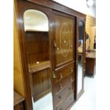 A vintage inlaid mahogany wardrobe with centre four-drawer chest, linen cupboard & matching dressing