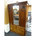 A vintage single door mirrored wardrobe with carved panels & three base drawers