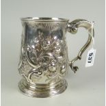 A bell-shaped silver mug with later repousse work & feather spur to the scrolled handle, hallmarks