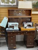 A sliding glass door bookcase, kneehole desk & two sewing machines Condition reports provided on