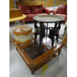 A brass Benares table on a carved stand together with a vintage footstool and a glass top coffee