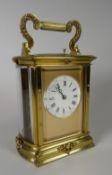A good brass encased repeated carriage clock, striking on a gong, having a circular white dial