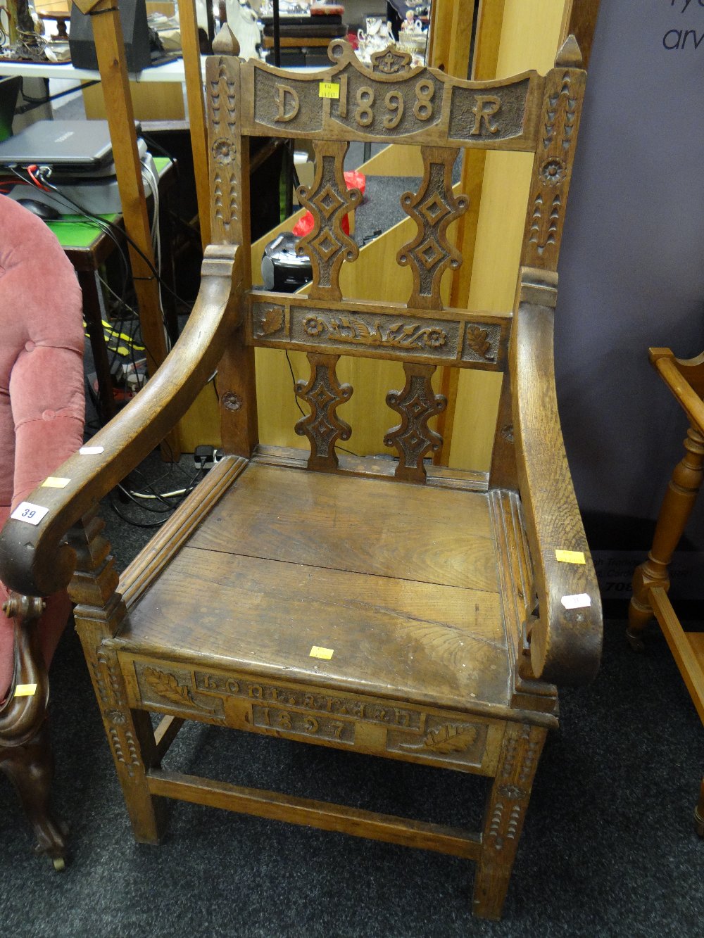 An 1897/1898 oak Eisteddfodic chair, carved with both dates & inscribed 'Bont ar dan' Condition
