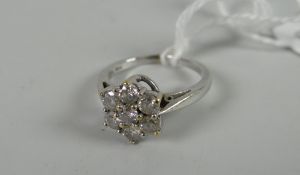 A white gold seven-stone diamond cluster ring Condition reports provided on request by email for