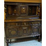 A 1920s dark oak court dresser, 170(h) x 155(l) x 61(d)cms