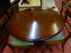 Reproduction mahogany circular topped pedestal dining table with four Regency style dining chairs