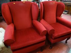 Pair of wine coloured wingbacked armchairs