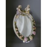 Continental porcelain easel mirror with cherub and floral decoration, 32 cms high