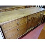 Victorian stripped pine dresser base of six opening drawers, small central drawer over a single