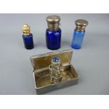 Three Bristol blue smelling salts bottles, various metal tops, small cherub cased example in clear