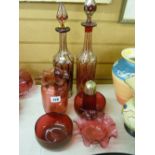 Two ruby red facet cut decanters and five pieces of cranberry glassware