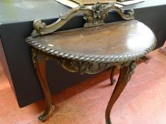 Edwardian mahogany half moon hall table with carved back rail and decoration