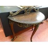 Edwardian mahogany half moon hall table with carved back rail and decoration