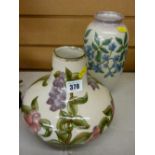 Two Cobridge stoneware vases in squat and baluster form, having painted floral decorations