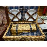 Wicker picnic basket with contents