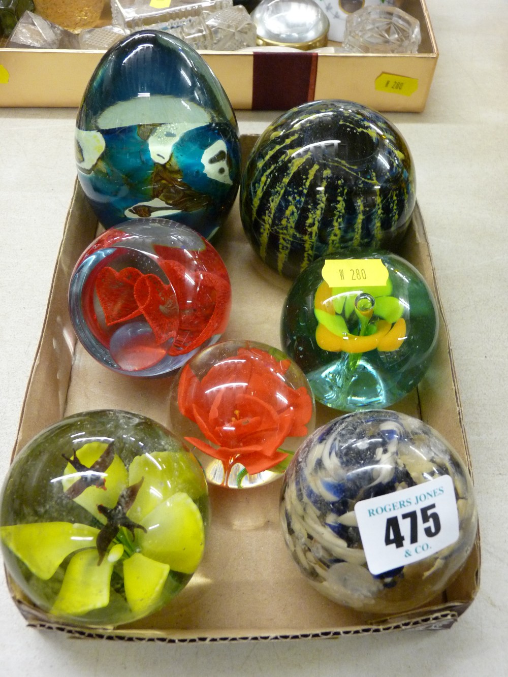 Seven vintage paperweights by Caithness, Mdina and others