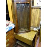 Wall hanging reproduction mahogany glass front corner cupboard and a twin flap oak two tier trolley