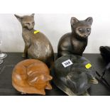 Four cat figurines, various composition