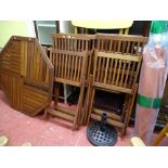 Octagonal garden table with folding chairs and metal based parasol