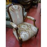 Late Victorian walnut salon armchair with carved detail on turned and reeded front supports with